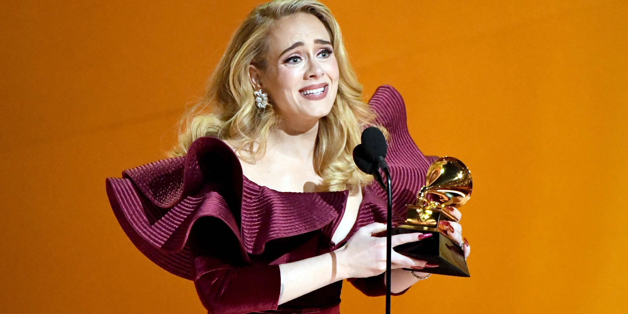 Adele Makes Stylish Return to the Grammys in Romantic Ruby Gown and Dazzling Diamonds
